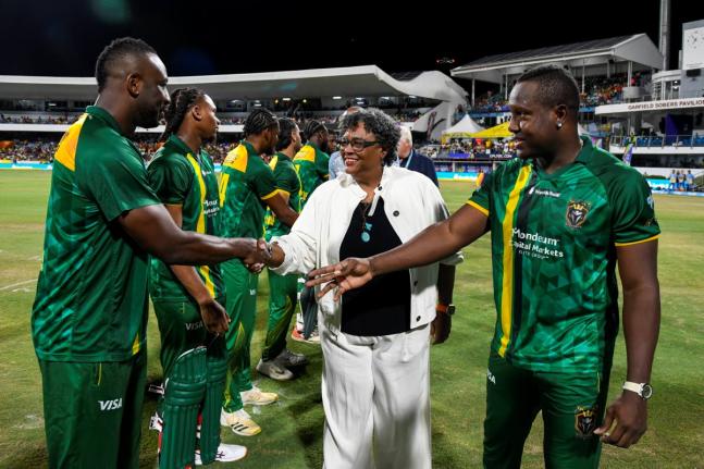 Barbados Primee Minister Mia Mottley (centre) is introduced to Jamaica Kingsmen all-rounder Andre Russell (left) by the team’s captain, Rovman Powell ahead of the start of the Republic Bank Caribbean Premier League final against the Antigua and Barbuda F